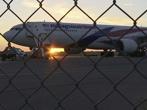 In this Thursday, Jan. 18, 2018 image made from video, Malaysia Airlines Flight 122 is on tarmac in Alice Springs, Australia. Passengers on the plane flying from Sydney to Kuala Lumpur which was forced to land in the central Australian city of Alice Springs said they were bracing themselves for a possible hard landing after the plane shook violently on Thursday. (Australian Broadcasting Corporation via AP)