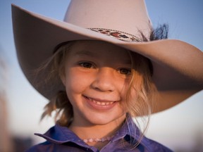 This photo taken in 2009 and provided by Akubra Hats, shows Amy "Dolly" Everett in Brunette Downs in the Northern Territory, Australia. Hundreds of people are remembering Dolly who was known as the angelic face of the Australian bushmen's hat brand and whose family says she killed herself after being targeted by cyberbullying. A memorial service for Dolly was held in the tiny Northern Territory town of Katherine on Friday, Jan. 12, 2018 near her family's cattle ranch. (Akubra Hats via AP)