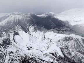 Ashes from Mount Kusatsu-Shirane cover near its summit after its eruption in Kusatsu, Gunma prefecture, central Japan, Tuesday, Jan. 23, 2018.