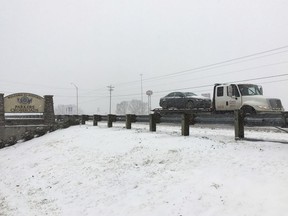 A flatbed tow truck carries a car along a road near Interstate 40 in snow and icy conditions on Friday, Jan. 12, 2018 in Parkers Crossroads, Tenn.