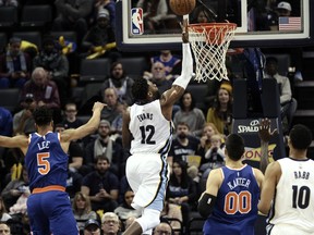 Memphis Grizzlies guard Tyreke Evans (12) shoots ahead of New York Knicks guard Courtney Lee (5) and center Enes Kanter (00) in the first half of an NBA basketball game Wednesday, Jan. 17, 2018, in Memphis, Tenn.