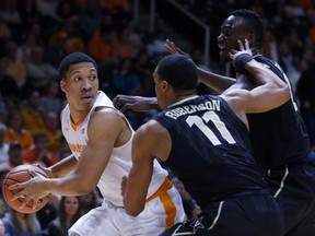 Tennessee forward Grant Williams (2) is defended by Vanderbilt forward Jeff Roberson (11) and Vanderbilt center Djery Baptiste, right, in the first half of an NCAA college basketball game Tuesday, Jan. 23, 2018, in Knoxville, Tenn.