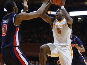 Tennessee forward Admiral Schofield (5) is defended by Auburn forward Horace Spencer (0) as he drives the ball toward the basket in the first half of an NCAA college basketball game Tuesday, Jan. 2, 2018, in Knoxville, Tenn.