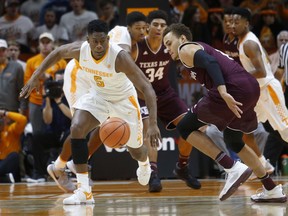 Tennessee forward Admiral Schofield, left, races toward the ball beside Texas A&M forward DJ Hogg, right, during the first half of an NCAA college basketball game Saturday, Jan. 13, 2018, in Knoxville, Tenn.