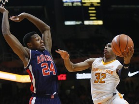 Tennessee guard Chris Darrington (32) is defended under the basket by Auburn forward Anfernee McLemore (24) in the first half of an NCAA college basketball game Tuesday, Jan. 2, 2018, in Knoxville, Tenn.