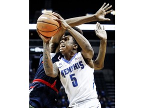 Memphis guard Kareem Brewton Jr., right, is fouled by a Connecticut player while driving the lane during the first half of an NCAA college basketball game in Memphis, Tenn., Tuesday, Jan. 16, 2018.