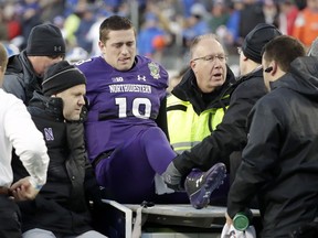 Northwestern quarterback Clayton Thorson (18) is put on a cart to be taken off the field after being injured in the first half of the Music City Bowl NCAA college football game against Kentucky, Friday, Dec. 29, 2017, in Nashville, Tenn.