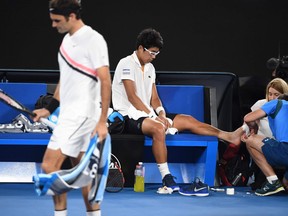 Heyon Chung receives medical attention during his Australian Open match against Roger Federer on Jan. 26.