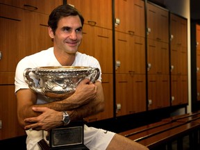 Roger Federer poses with the Norman Brookes Challenge Cup at the Australian Open on Jan. 28.