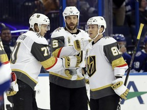 Vegas Golden Knights center William Karlsson (71) celebrates his goal against the Tampa Bay Lightning with defenseman Deryk Engelland (5) and center Jonathan Marchessault (81) during the third period of an NHL hockey game Thursday, Jan. 18, 2018, in Tampa, Fla.
