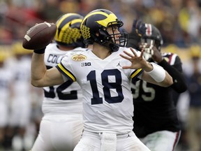 Michigan quarterback Brandon Peters (18) throws a pass against South Carolina during the first half of the Outback Bowl NCAA college football game Monday, Jan. 1, 2018, in Tampa, Fla.