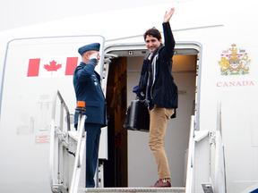 Prime Minister Justin Trudeau boards a government plane headed for China on Dec. 2, 2017. During the week-long official trip, more than $2,200 worth of alcohol — 121 bottles of wine and 241 cans of beer — was consumed on flights.