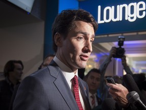 Prime Minister Justin Trudeau talks with reporters following a meeting with business leaders at the World Economic Forum Wednesday, January 24, 2018 in Davos, Switzerland.