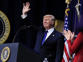 President Donald Trump waves after speaking at the Conversations with the Women of America at the Eisenhower Executive Office Building on the White House complex in Washington, Tuesday, Jan. 16, 2018.
