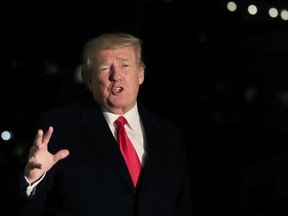 President Donald Trump speaks to reporters upon arrival at the White House in Washington, Friday, Jan. 26, 2018, from the World Economic Forum in Davos, Switzerland.