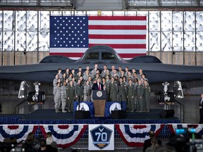 U.S. President Donald Trump, center, delivers remarks to military personnel and families in an aircraft hangar at Joint Base Andrews, Maryland, U.S., on Friday, Sept. 15, 2017.