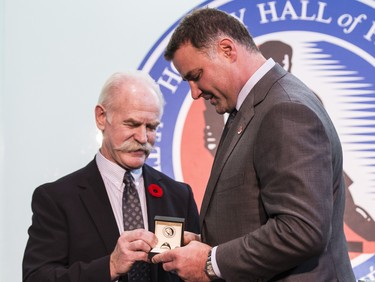 Eric Lindros receives his Hockey Hall of Fame ring from Lanny McDonald in Toronto on Nov. 11, 2016.