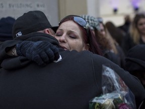 Shanan Dionne, mother of Rori Hache, an 18-year-old girl who was murdered earlier this year, receives a hug following her speech at the memorial service for her daughter at Memorial Park in Oshawa, Ontario, December 9, 2017.