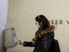 A subway rider attempts to use an interactive art installation at the new Pioneer Village station in Toronto.