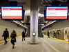 Subway riders walk past an interactive art installation at the new Pioneer Village station in Toronto.