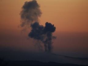 FILE - In this Saturday, Jan. 20, 2018 file photo, plumes of smoke rise on the air from inside Syria, as seen from the outskirts of the border town of Kilis, Turkey. Turkey's military offensive on the Syrian border town of Afrin, controlled by Kurdish fighters, has been long in coming. Turkish officials have been threatening to launch the offensive and preparing for it for months. But there have been shades of gray in Ankara's professed goals about the military incursion, which was launched on Saturday.