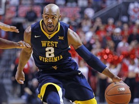 West Virginia's Jevon Carter (2) dribbles the ball down the court during the first half of an NCAA college basketball game against Texas Tech, Saturday, Jan. 13, 2018, in Lubbock, Texas.