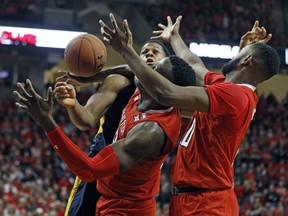 West Virginia's Sagaba Konate (50), Texas Tech's Norense Odiase (32) and Niem Stevenson (10) try to rebound the ball during the second half of an NCAA college basketball game, Saturday, Jan. 13, 2018, in Lubbock, Texas.