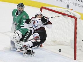 Colorado Avalanche center Alexander Kerfoot (13) stumbles in front of the net after score a goal against Dallas Stars goaltender Ben Bishop (30) during the first period of an NHL hockey game, Saturday, Jan. 13, 2018, in Dallas.