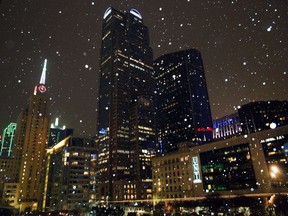 A mixture of snow and sleet falls in downtown Dallas on Monday evening, Jan. 15, 2018, as a cold front slowly moved across the Metroplex.