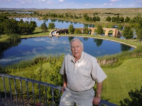 FILE - In this May 30, 2017, file photo, oil tycoon T. Boone Pickens poses for a photo before a series of man-made lakes leading from The Lake House to The Lodge on his Mesa Vista Ranch in the panhandle of Texas. Pickens announced Friday, Jan. 12, 2018, that he is closing his Dallas energy-focused hedge fund. In a statement published on LinkedIn, the 89-year-old Pickens says that "it's no secret the past year has not been good to me, from a health perspective or a financial one."