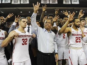 Houston head coach Kelvin Sampson, center, celebrates with his team Houston's 73-59 win over Wichita State in an NCAA college basketball game, Saturday, Jan. 20, 2018, in Houston.