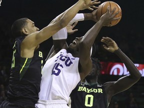 TCU forward JD Miller (15) is fouled by Baylor forward Tristan Clark, left, during the first half of an NCAA college basketball game Tuesday, Jan. 2, 2018, in Waco, Texas.