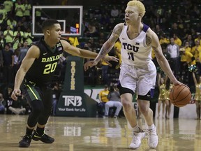 TCU guard Jaylen Fisher (0) is guarded by Baylor guard Manu Lecomte (20) during the first half of an NCAA college basketball game Tuesday, Jan. 2, 2018, in Waco, Texas.