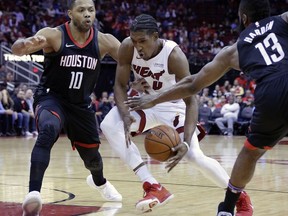 Miami Heat forward Josh Richardson (0) has the ball knocked away between Houston Rockets guards Eric Gordon (10) and James Harden (13) during the first half of an NBA basketball game Monday, Jan. 22, 2018, in Houston.