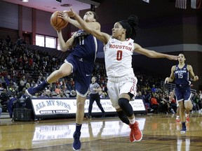 Connecticut guard Kia Nurse (11) puts up a shot past Houston guard Angela Harris (0) during the first half of an NCAA college basketball game Saturday, Jan. 13, 2018, in Houston, Texas.