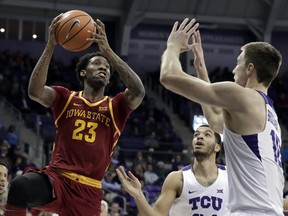 Iowa State forward Zoran Talley Jr. (23) goes up for a shot as TCU's Kenrich Williams, center, and Vladimir Brodziansky (10), of Slovakia, defend in the first half of an NCAA college basketball game, Wednesday, Jan. 17, 2018, in Fort Worth, Texas.