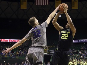Kansas State forward Dean Wade, left, blocks the shot of Baylor guard King McClure, right, in the first half of an NCAA college basketball game, Monday, Jan. 22, 2018, in Waco, Texas.