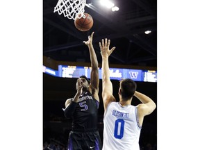 Washington guard Jaylen Nowell, left, shoots over UCLA forward Alex Olesinski during the first half of an NCAA college basketball game in Los Angeles, Sunday, Dec. 31, 2017.