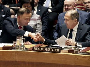 Poland's President Andrzej Duda, left, shakes hands with Russia's Foreign Minister Sergei Lavrov in the United Nations Security Council, Thursday, Jan. 18, 2018.