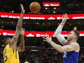 Utah Jazz forward Derrick Favors, left, goes up for a block against Los Angeles Clippers forward Blake Griffin (32) in the first half during an NBA basketball game Saturday, Jan. 20, 2018, in Salt Lake City.
