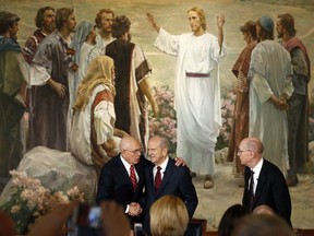 President Russell M. Nelson, center, receives a hand shake from his counselor Dallin H. Oaks, left, while fellow counselor Henry B. Eyring, right, looks on following a news conference announcing his new leadership in the wake of the death of President Thomas S. Monson Tuesday, Jan. 16, 2018, in Salt Lake City.