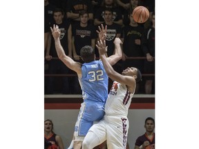 Virginia Tech's Kerry Blackshear Jr. (24) collides with North Carolina's Luke Maye (32) during the first half of an NCAA college basketball game in Blacksburg, Va. Monday, Jan. 22, 2018.