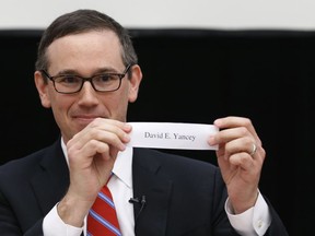 Virginia State Board of Elections chairman, James Alcorn, holds up the name of David Yancy, the winner of a drawing to determine the winner of a tied election for the 94th district House of Delegates seat at the Capitol in Richmond, Va., Thursday, Jan. 4, 2018. Yancey won the drawing over Democrat Shelly Simonds.