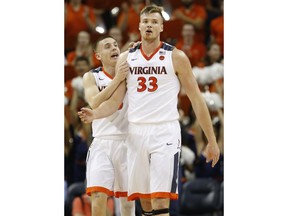 Virginia guard Kyle Guy (5) talks with teammate Jack Salt (33) during the first half of an NCAA college basketball game in Charlottesville, Va., Tuesday, Jan. 23, 2018.