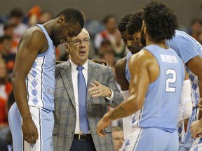 North Carolina head coach Roy Williams talks with his team during the second half of an NCAA college basketball game against Virginia in Charlottesville, Va., Saturday, Jan. 6, 2018. Virginia won 61-49.