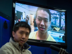 Wilfred Wong speaks about his brother Alfred Wong, 15, seen on a television, who was an innocent victim of an alleged gang shooting, during a Vancouver Police news conference in Vancouver, B.C., on Monday January 22, 2018. Wong was hit by a stray bullet as his family was driving in Vancouver on January 13.