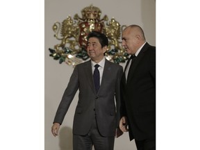 Japanese Prime Minister Shinzo Abe and Bulgarian Prime Minister Boiko Borissov, right,  meet in Sofia, Sunday, Jan. 14, 2018. Abe is visiting Bulgaria as part of his East European tour.