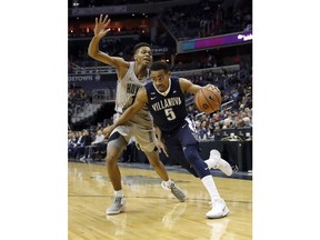 Villanova guard Phil Booth (5) drives past Georgetown forward Jamorko Pickett (1) during the first half of an NCAA college basketball game, Wednesday, Jan. 17, 2018, in Washington.