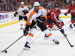 Philadelphia Flyers right wing Wayne Simmonds (17) skates with the puck Washington Capitals defenseman Christian Djoos (29), of Sweden, during the first period of an NHL hockey game, Sunday, Jan. 21, 2018, in Washington.