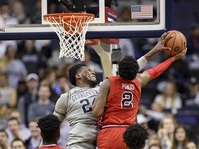 Georgetown forward Marcus Derrickson (24) blocks St. John's guard Shamorie Ponds (2) during the first overtime of an NCAA college basketball game, Saturday, Jan. 20, 2018, in Washington. Georgetown won 93-89 in double overtime.